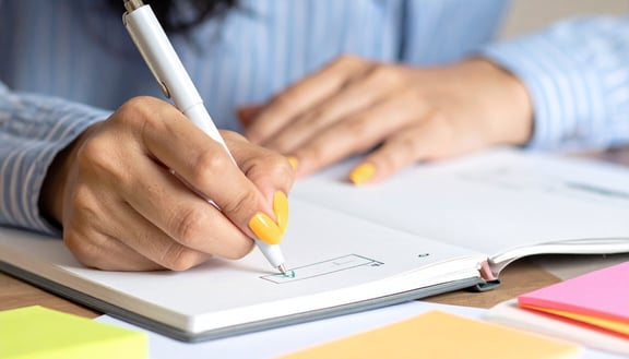 beesite recruiterin erstellt eine checkliste Nahaufnahme gelbe Fingernägel